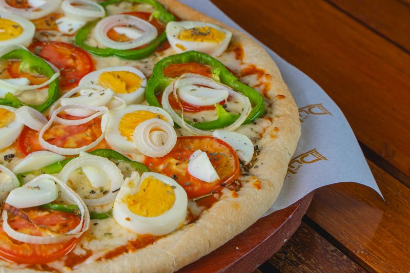 fresh veggie pizza with colorful toppings at modpizza