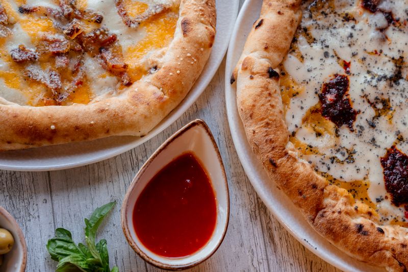 spicy italian sausage pizza slice at mods pizza restaurant